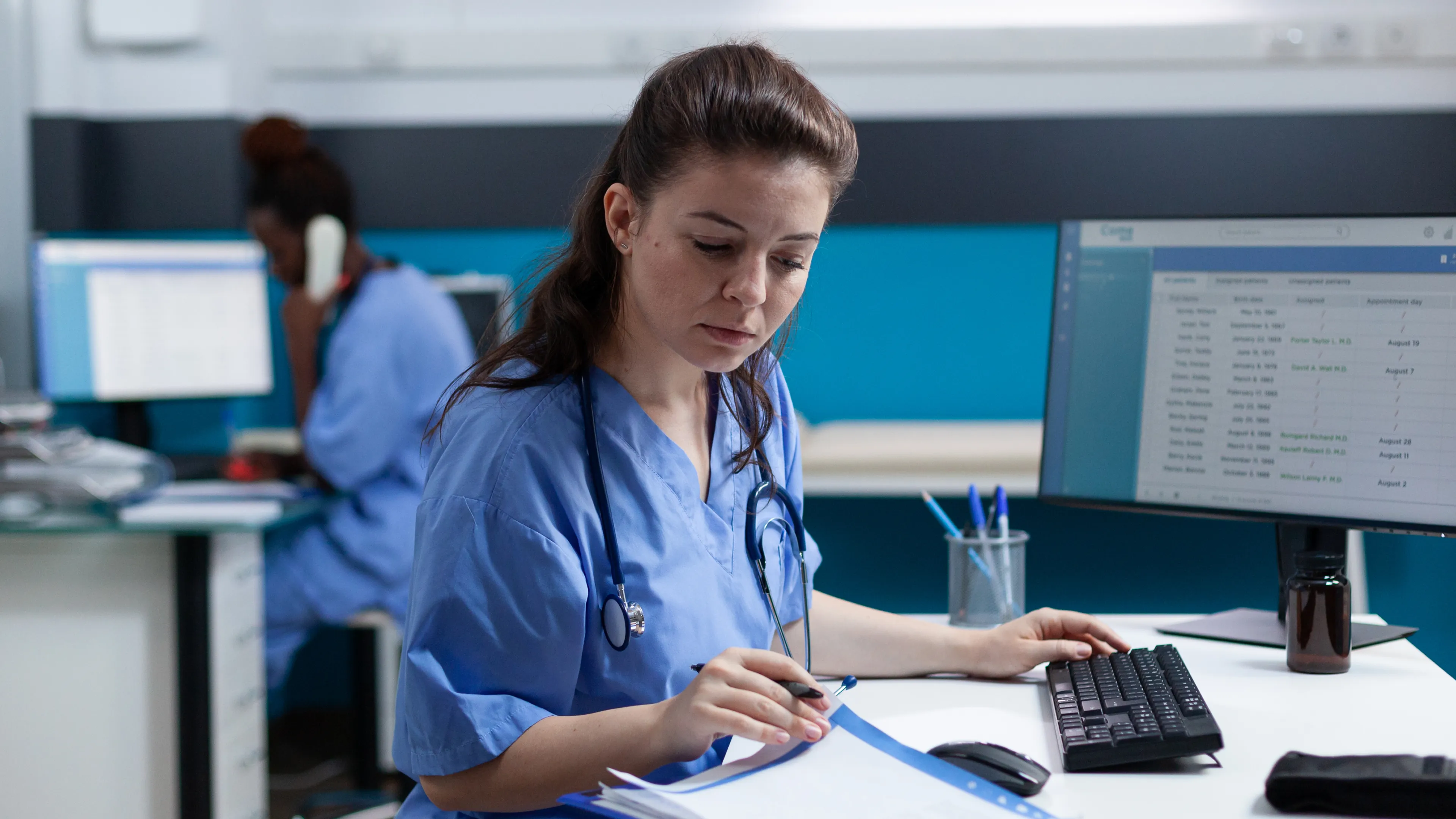 Pharmacist reviewing patient medication records on a clinical workstation